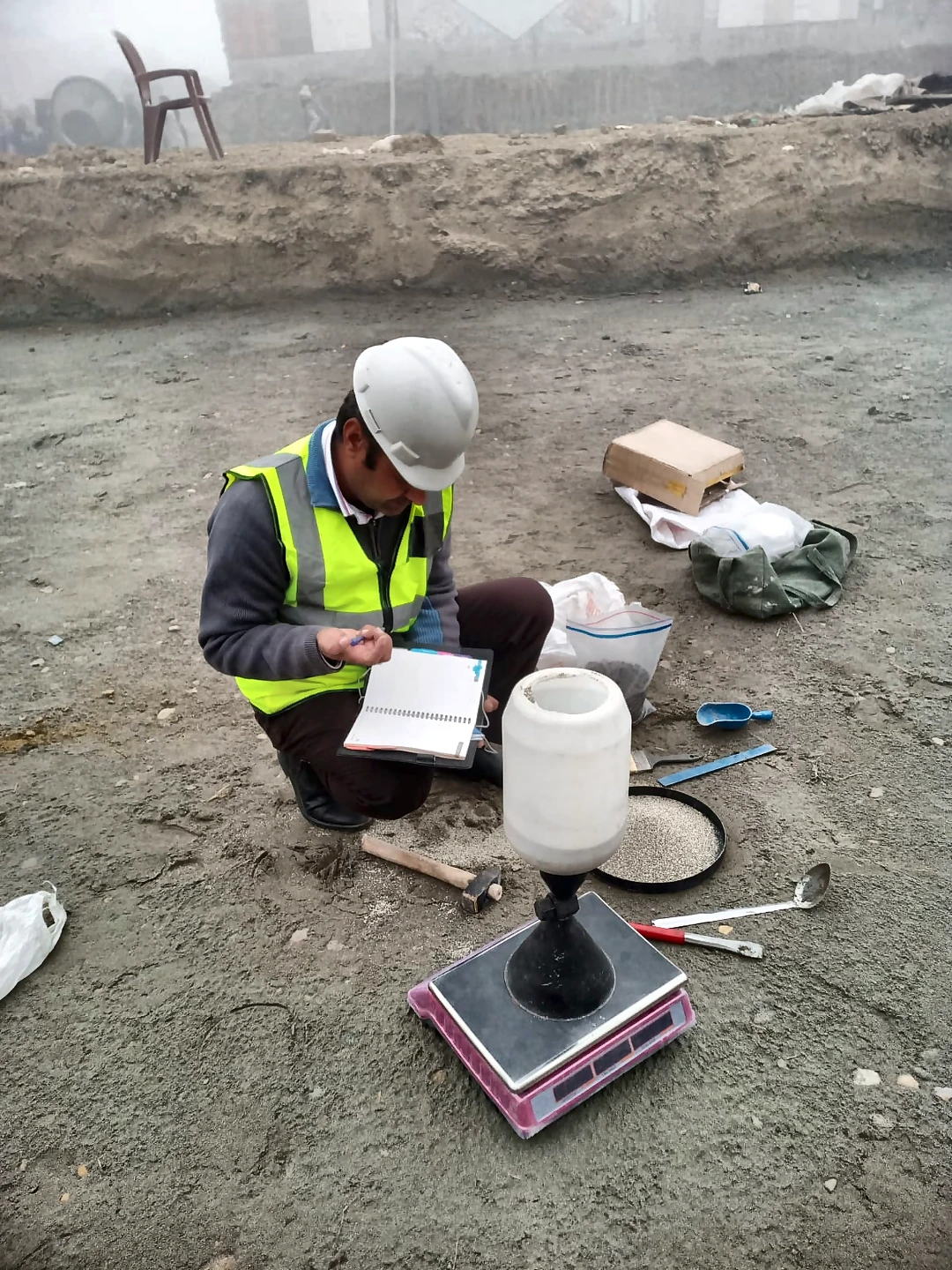 Caliber technician conducting a field-density test with sand-cone equipment