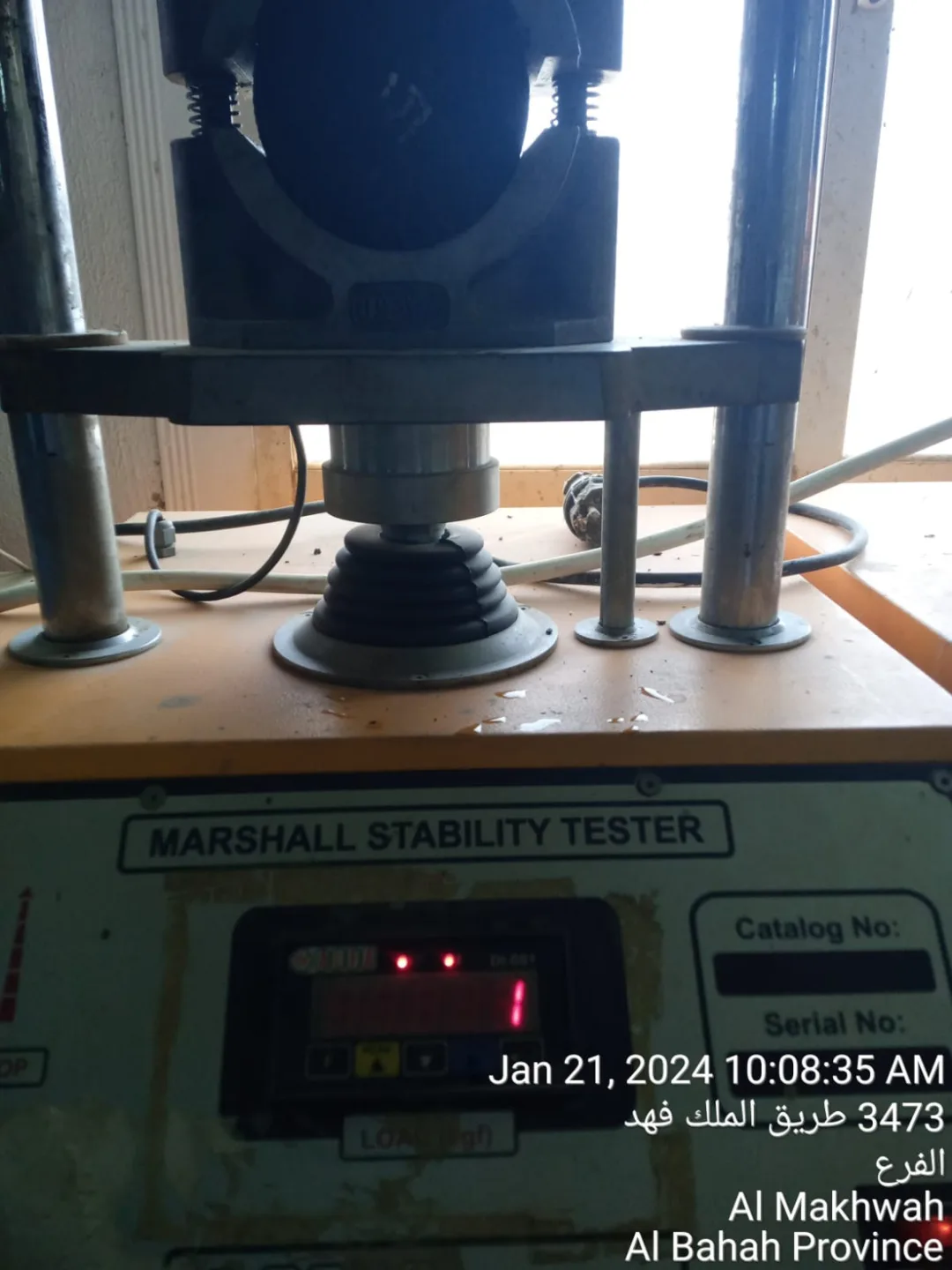 Marshall stability testing equipment evaluating an asphalt specimen